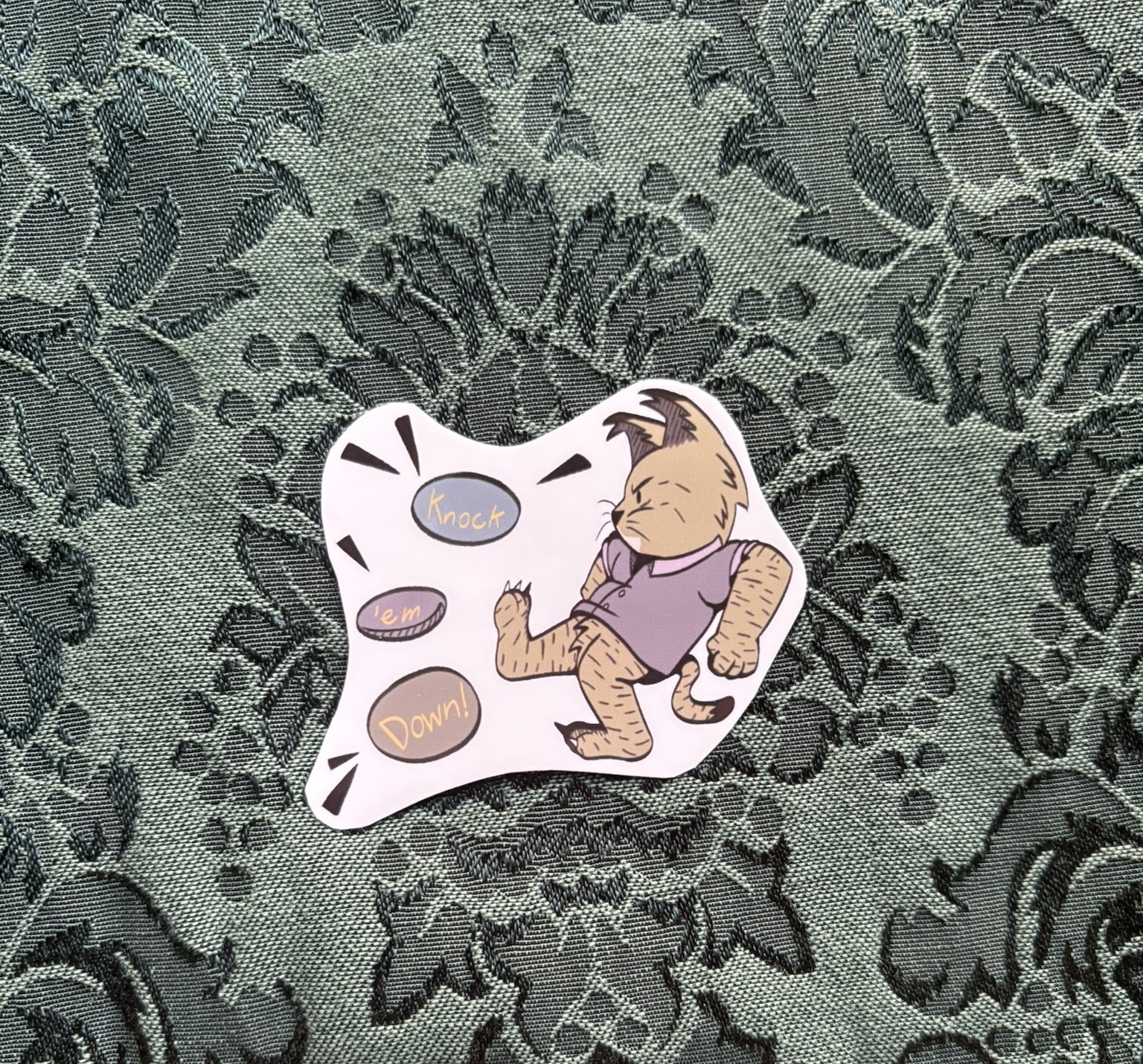 Picture of a bobcat kicking over a stack of rocks. Text reads KNOCK THEM DOWN!