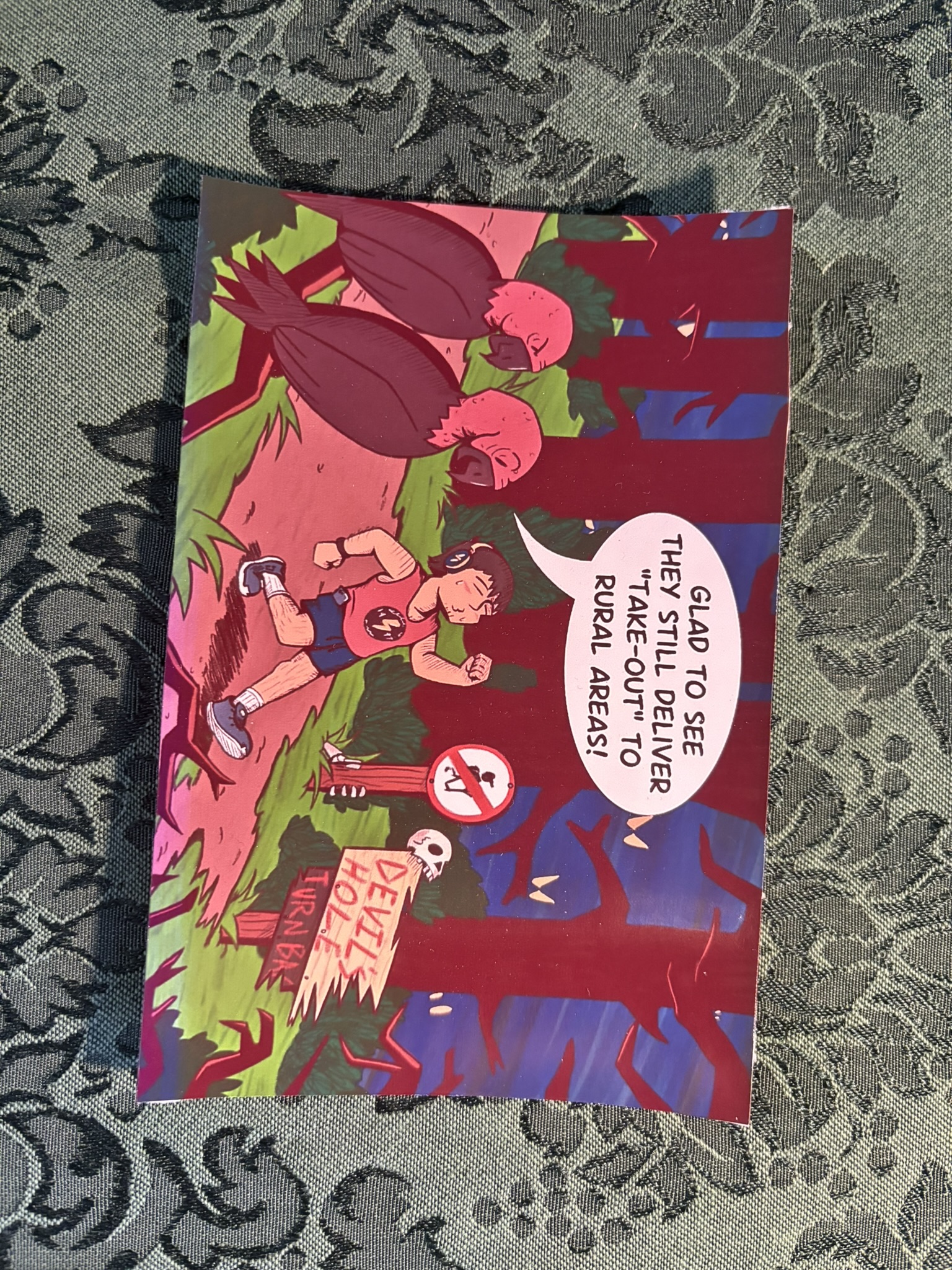 A 4 by 6 inch, glossy poster print. It shows a carefree man walking through a dark and scary forest.Two vultures watch from a branch. One says they're glad to see they still deliver take-out to rural areas.