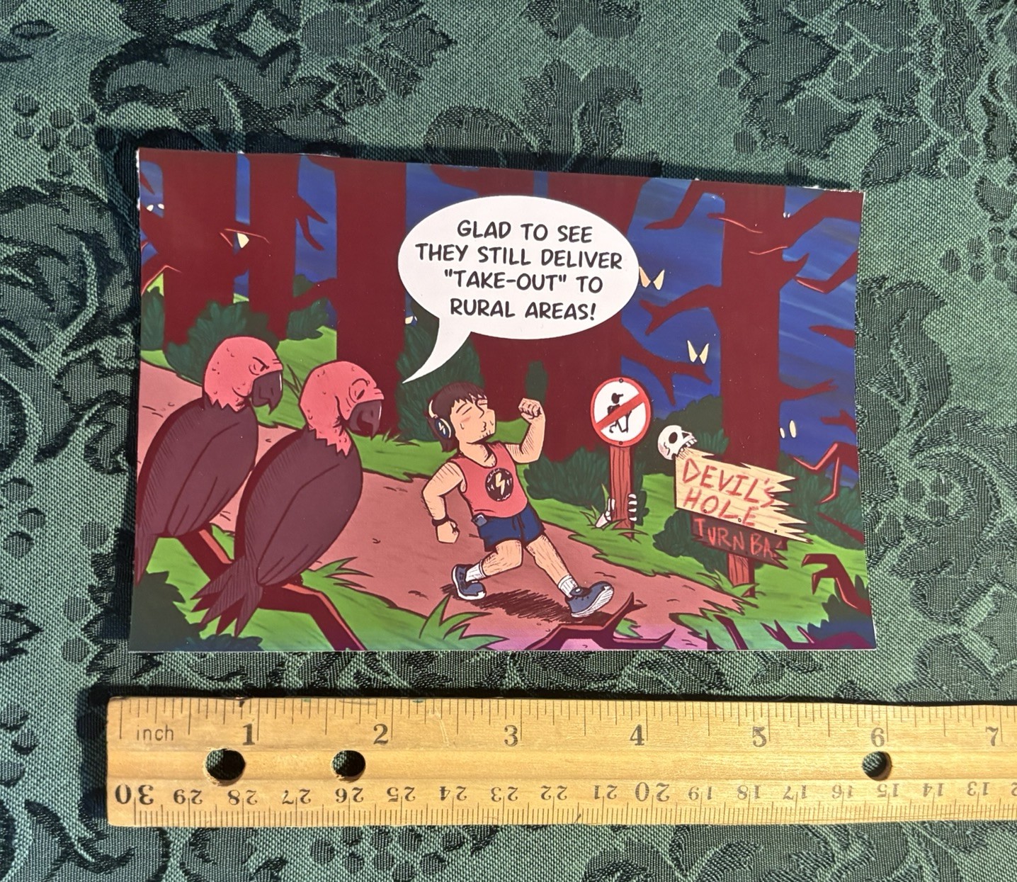 A 4 by 6 inch, glossy poster print. It shows a carefree man walking through a dark and scary forest.Two vultures watch from a branch. One says they're glad to see they still deliver take-out to rural areas.