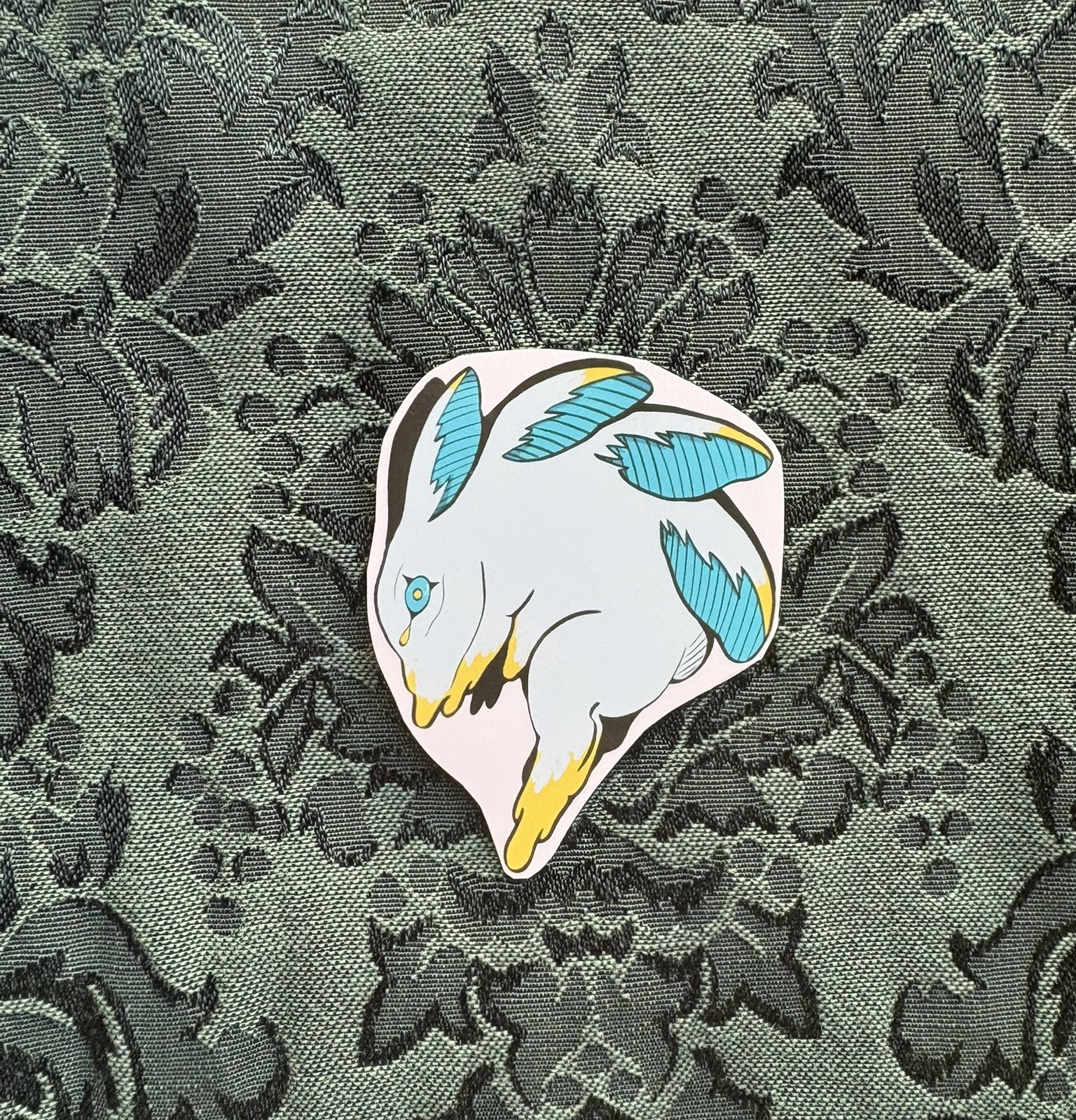 Picture of a melting blue rabbit with 4 pairs of ears