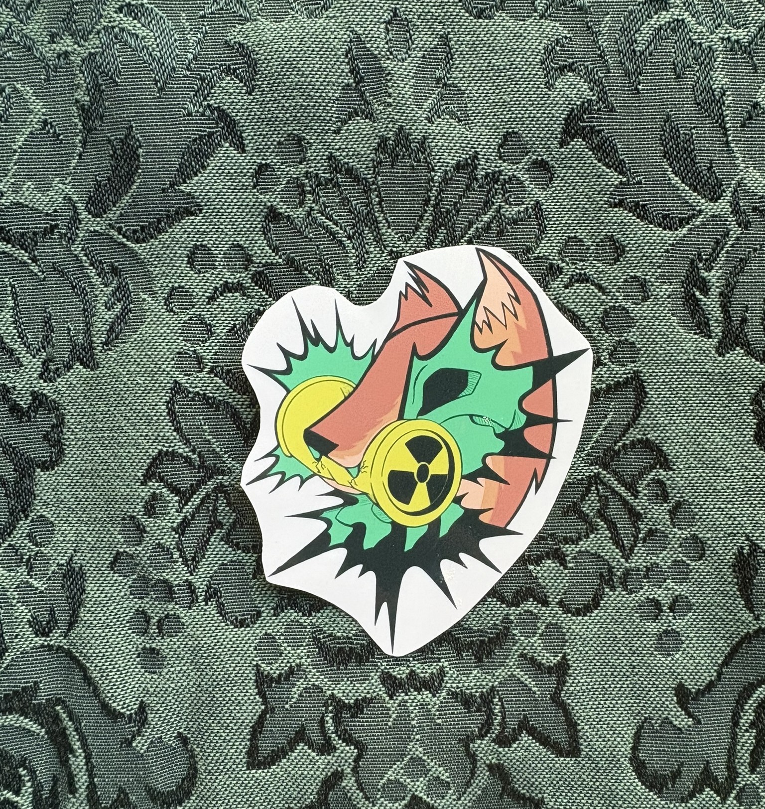 Picture of an orange coyote biting into a radioactive can. Parts of its skeleton can be seen in a flash of light.